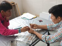 Researchers Franz Beyuma and Gabriel Supa observe the differences in the ceramic samples